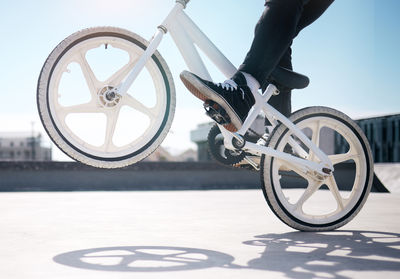 Low section of man riding bicycle on street