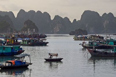 Boats sailing in sea against sky