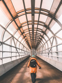 Rear view of woman walking in bus