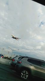 Cars on airplane against sky