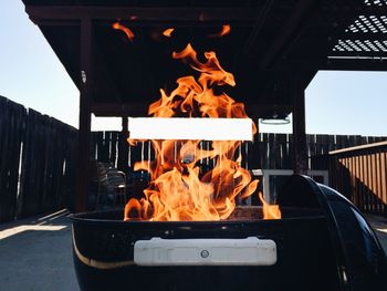 Flames over barbecue in back yard