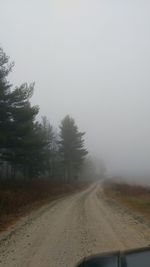 Road passing through foggy weather