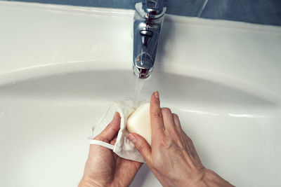 Close-up of hands in bathroom