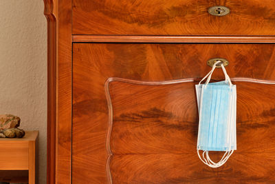 Close-up of clothes hanging on wood at home