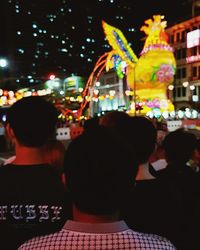 Rear view of people at night