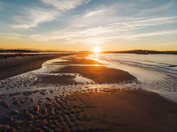 Scenic view of beach against sky during sunset