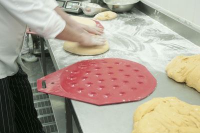 Midsection of man preparing food