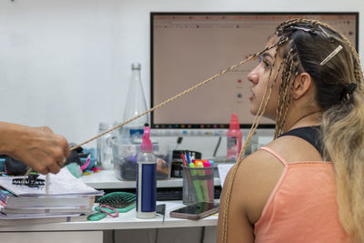 Portrait of a beautiful girl with senegalese of preparation for senegalese pigtails.