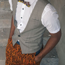 Midsection of man waistcoat while standing on steps