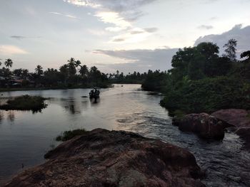 Scenic view of river against sky during sunset