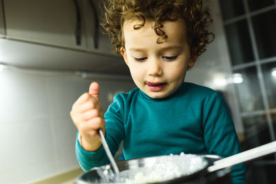 Cute girl preparing food at kitchen