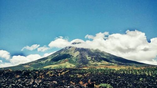 Scenic view of mountains against cloudy sky