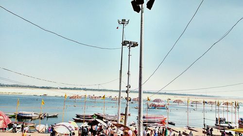 Floodlights against river and sky on sunny day