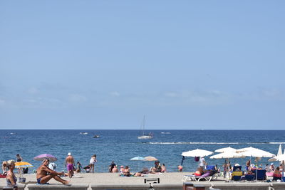 People on beach against sky