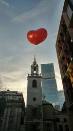 Low angle view of buildings against sky at sunset