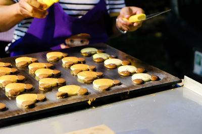 Midsection of person preparing food