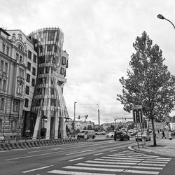 View of city street against cloudy sky