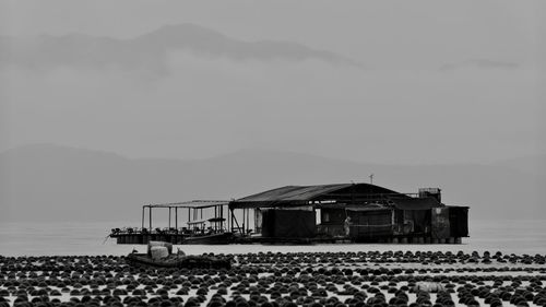 Building by sea against sky