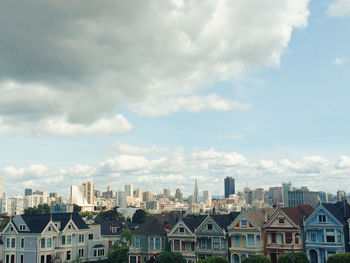 Cityscape against cloudy sky
