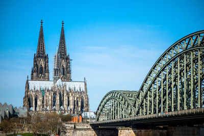 Hohenzollern bridge and cologne cathedral against blue sky