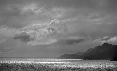 Scenic view of sea against sky with storm clouds forming