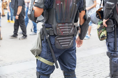 Midsection of police officers on street