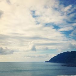 Scenic view of sea against cloudy sky