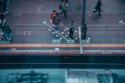 High angle view of people walking on road in city