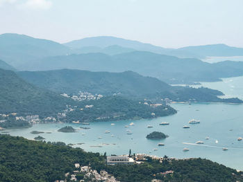 High angle view of townscape by sea against sky