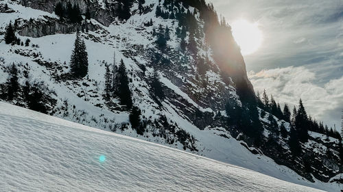 Scenic view of snow covered mountains against sky