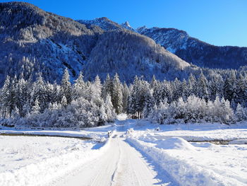 Snow covered landscape against sky