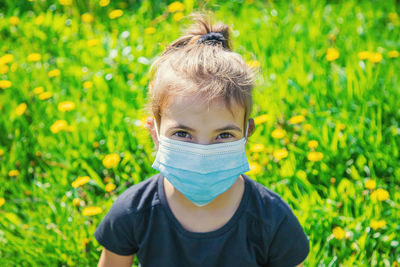 Portrait of girl wearing protective face mask in garden