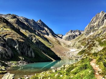 Scenic view of lake and mountains against clear sky