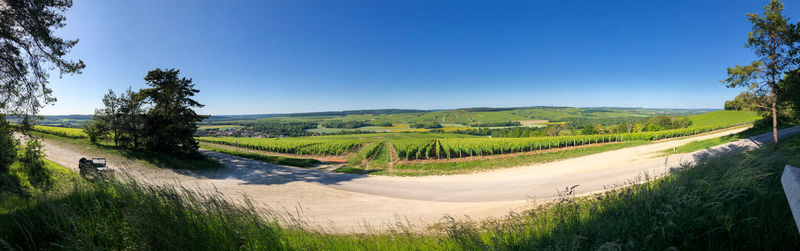 Scenic view of land against clear blue sky