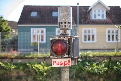 Close-up of road sign against built structure