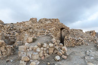 Old ruins of building against cloudy sky