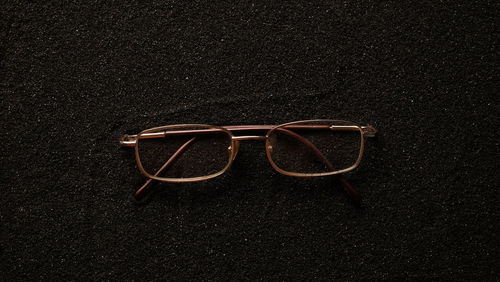 High angle view of sunglasses against black background