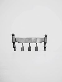 Close-up of empty chairs on table against white background