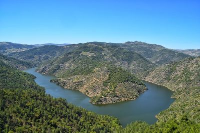 Scenic view of mountains against clear blue sky