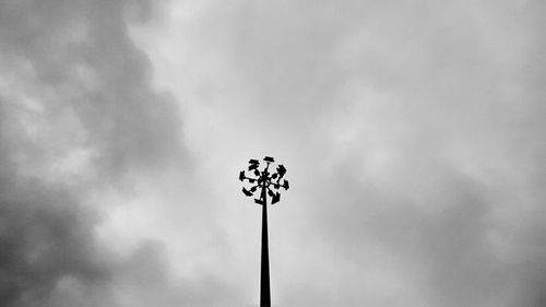 Low angle view of street light against cloudy sky