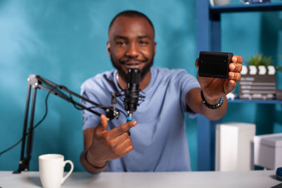 Midsection of man using mobile phone