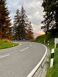  mountain road by trees against sky