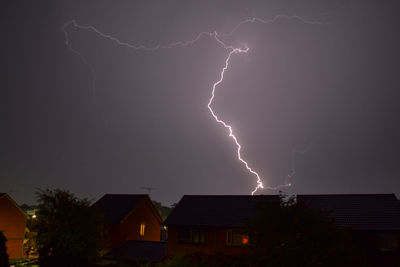 Lightning over cityscape against dramatic sky