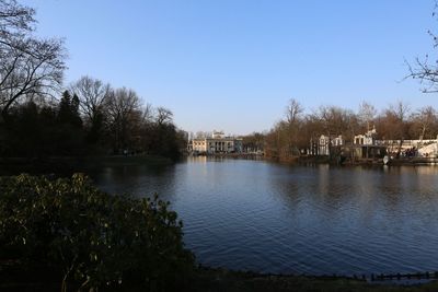 Calm lake against clear sky