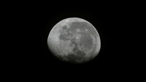 Low angle view of moon against sky at night