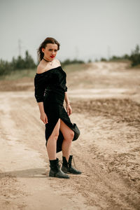 Portrait of beautiful young woman on land