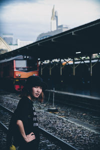 Portrait of woman standing on railroad station platform