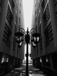 Low angle view of street light against buildings