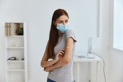 Portrait of beautiful woman standing at home