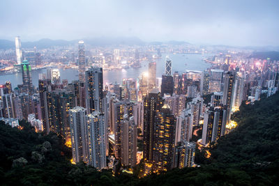 High angle view of illuminated city buildings against sky